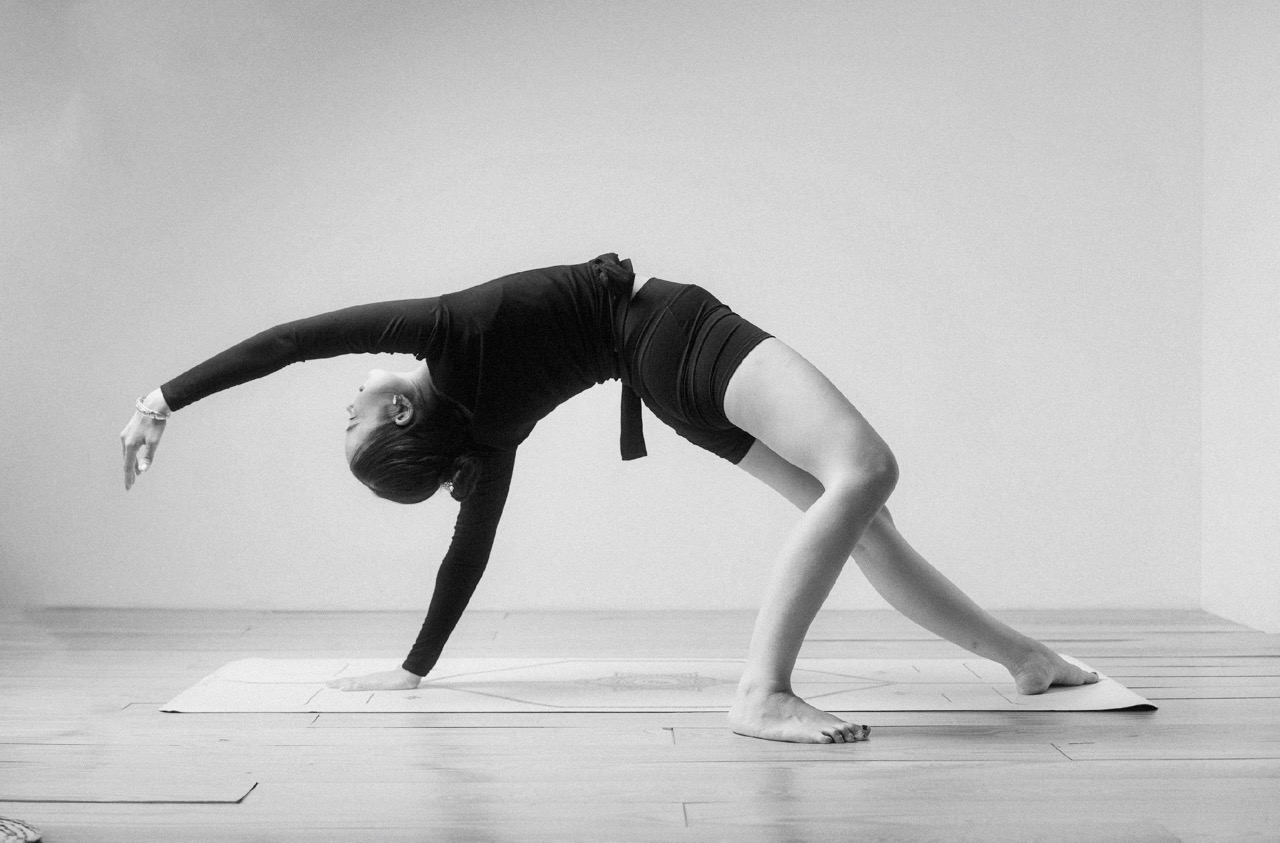 Woman in a graceful yoga backbend on a mat